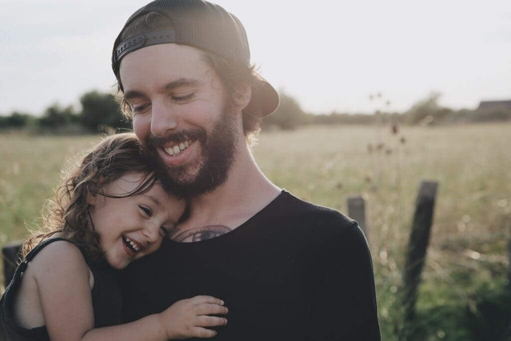 Father's Day, man carrying daughter in black sleeveless top